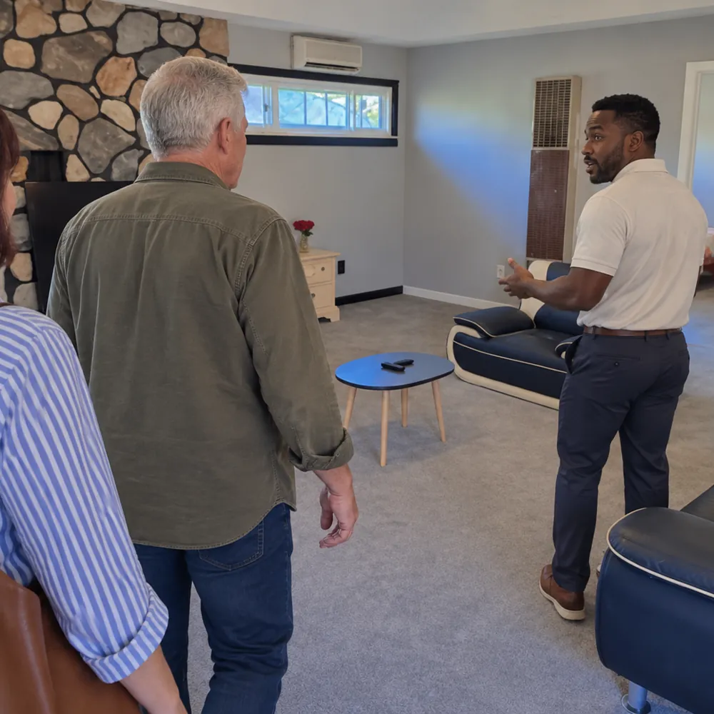 A family touring the living room at American Golden Care
