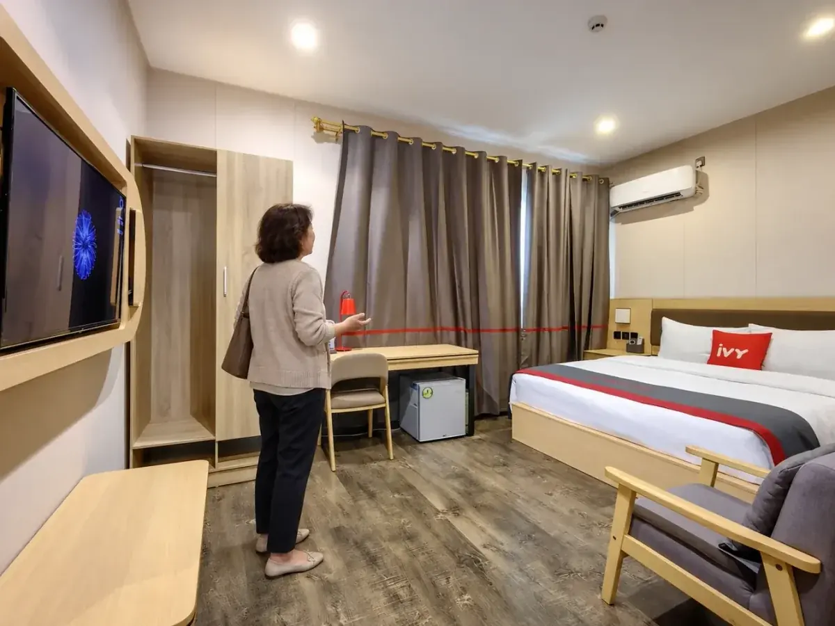 A visitor looking around a bedroom