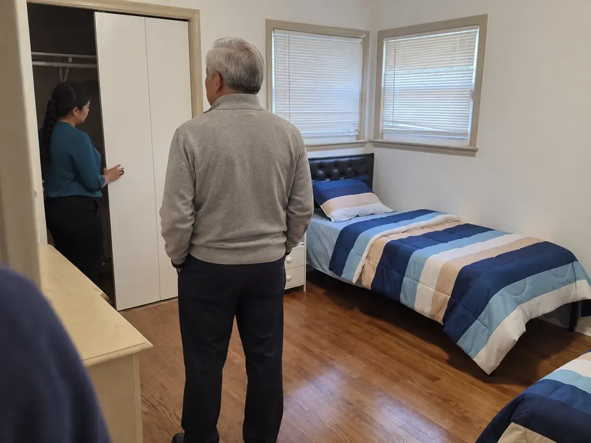 A visitor looking at a single bedroom