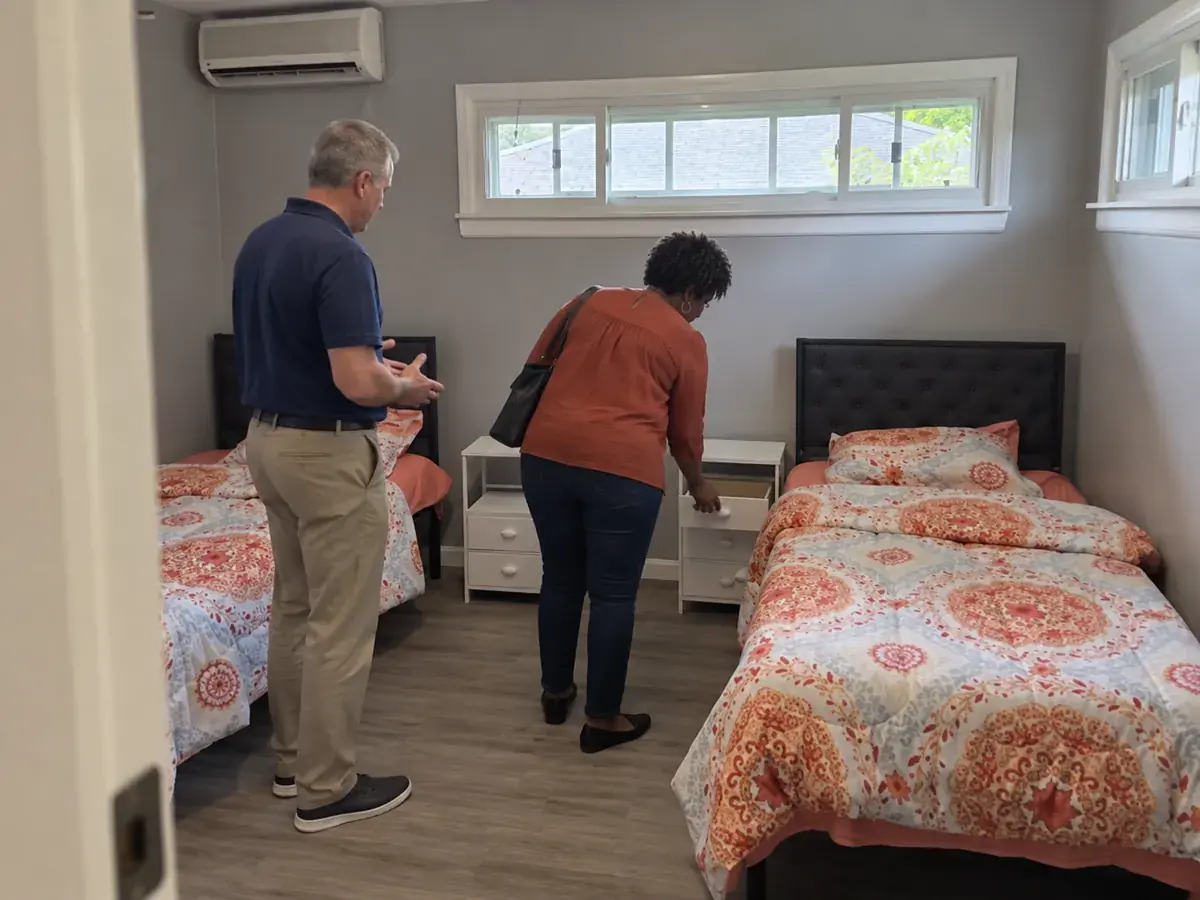 A couple looking at a shared bedroom